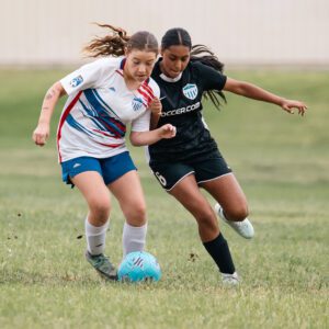 Girls playing for AYSO Section 1 Alliance in a competitive youth soccer pathway match